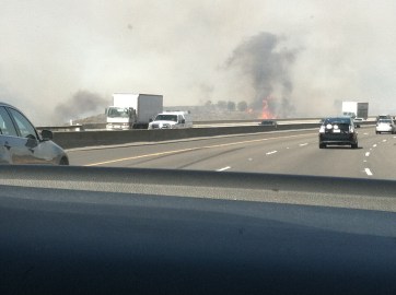 The hills were covered in smoke and there were fires all over...even right by the highway.